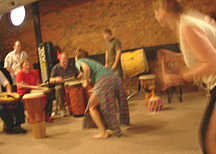 Left to right: Steve Kellar (hands), Toni Kellar and Andy Hall (sitting), and Matt Smith and Andy McVey�(standing) drum for Molly Watson and dancers